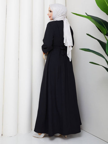 Robe longue ceinturé à boutons dorsaux. Alhambra Couture